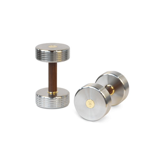 Premium dumbbell combining solid wood grip, polished steel, and gold-plated detailing.