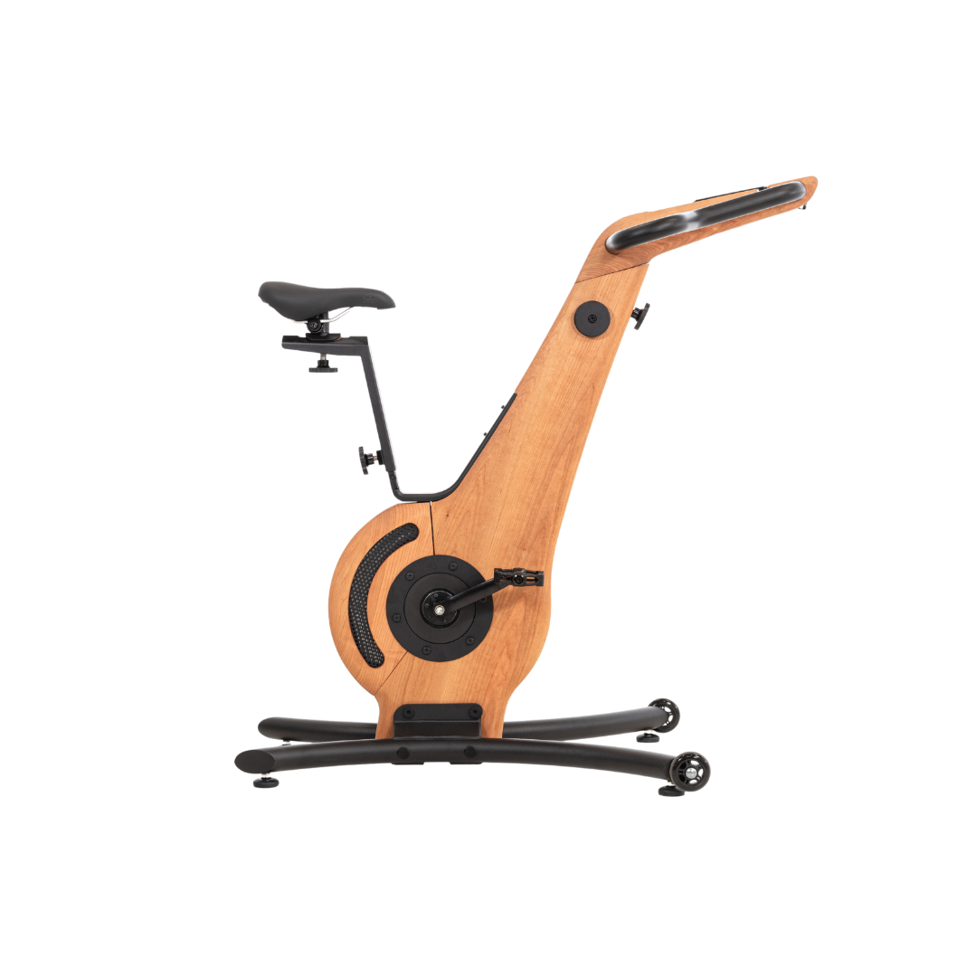 A modern exercise bike with cherry wooden frame and minimalist design, featuring an adjustable seat and streamlined structure. NOHRD Bike V2