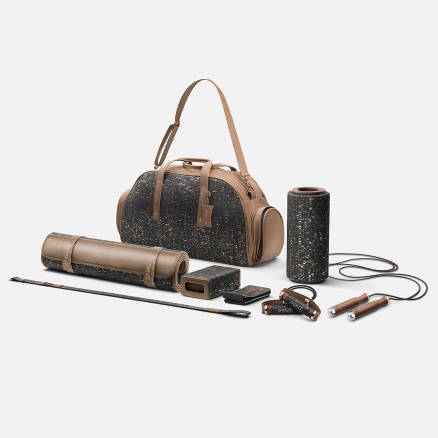 A fitness bag with various equipment including a yoga mat, foam roller, yoga block, resistance bands, and jump rope, all in brown and gold. PENT. Torba Fitness Set
