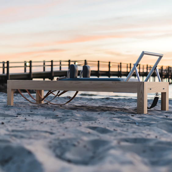 PILATES SCANDINAVIA Reformer displayed near beach.