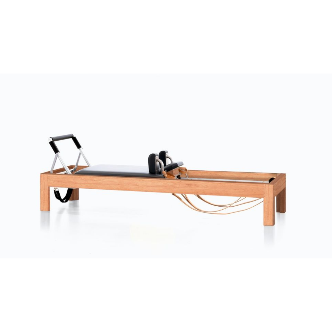 Luxury reformer combining cherry wood, birch, and precision craftsmanship.