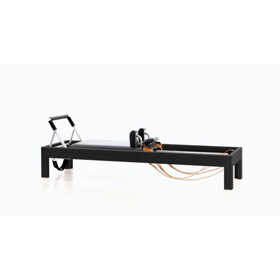 Luxury reformer combining shadow wood, birch, and precision craftsmanship.