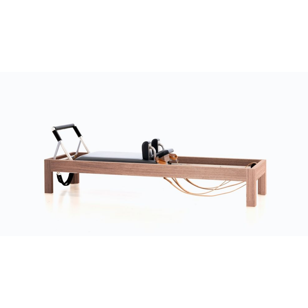 Luxury reformer combining vintage wood, birch, and precision craftsmanship.