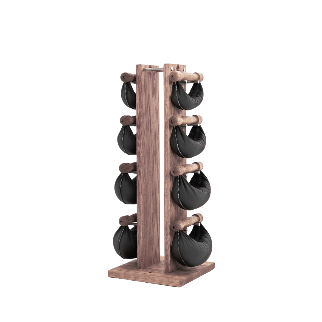 Six black leather swingbell are neatly arranged on a vintage wooden rack, highlighting craftsmanship and simplicity in design. NOHRD Swing Tower - Leather Dumbbell Set