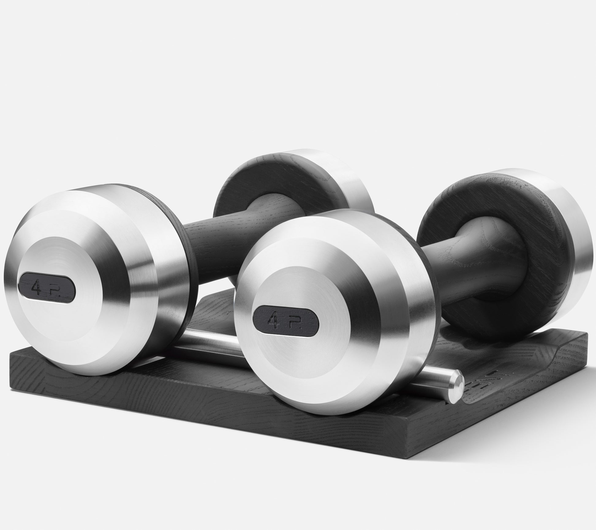 Side view of Luxury dumbbells made with black ash wood and stainless steel on black ash wooden stand. Available in weights ranging between 2 - 30kg. PENT. COLMIA - Luxury Dumbbells on Wooden Stand