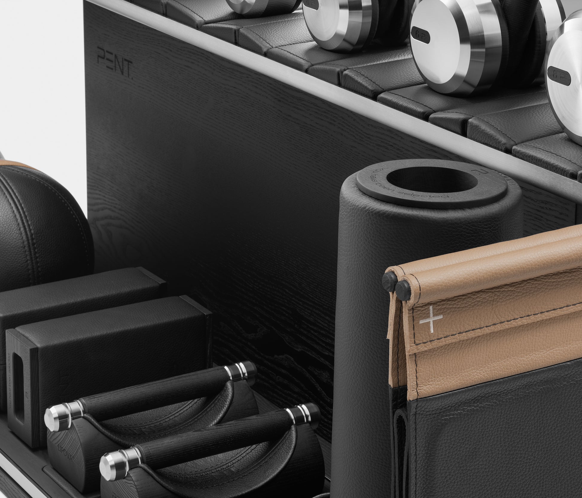 PENT. ANA: Skipping rope, push up bars, fitness mat, dumbbells, kettlebells, stretching roller, yoga blocks and leather medicine balls. Handcrafted with stainless steel, premium Italian black base leather, brown accent leather and black ash wood.