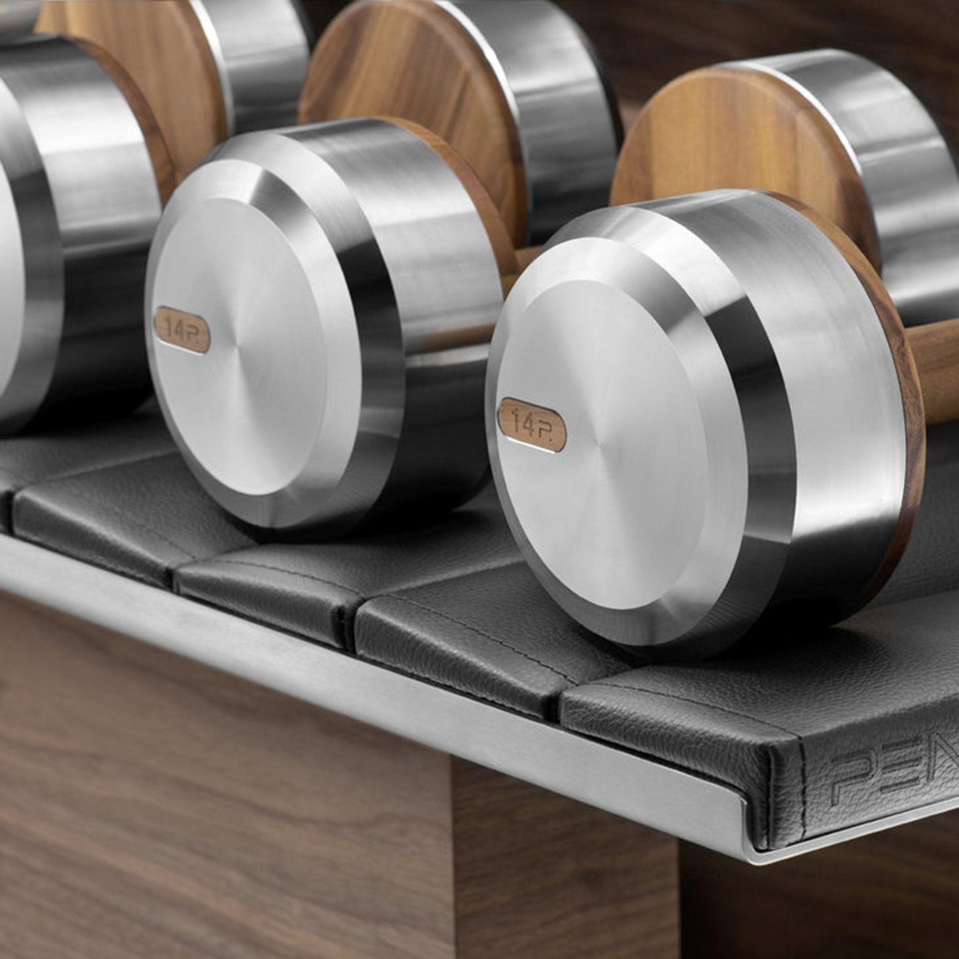 Close up view of the dumbbells, PENT. COLMIA Set - Dumbbells on a Horizontal Wooden Stand