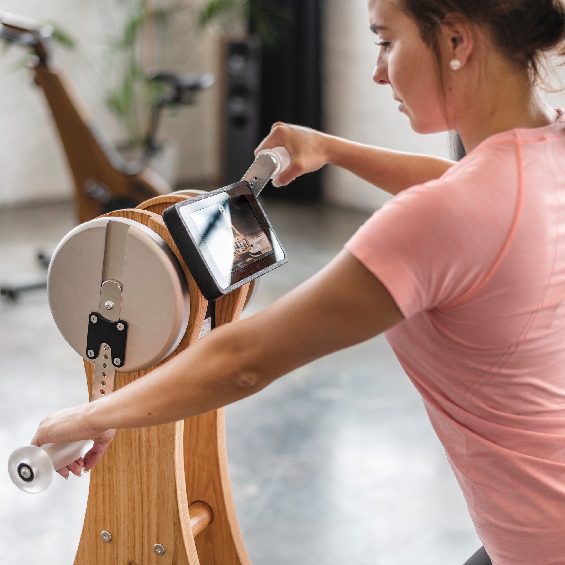 A fitness model using the luxury gym equipment, water grinder for cardio workout. NOHRD WaterGrinder.