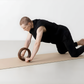 Abdominal roller crafted from premium walnut wood with a central rolling surface.