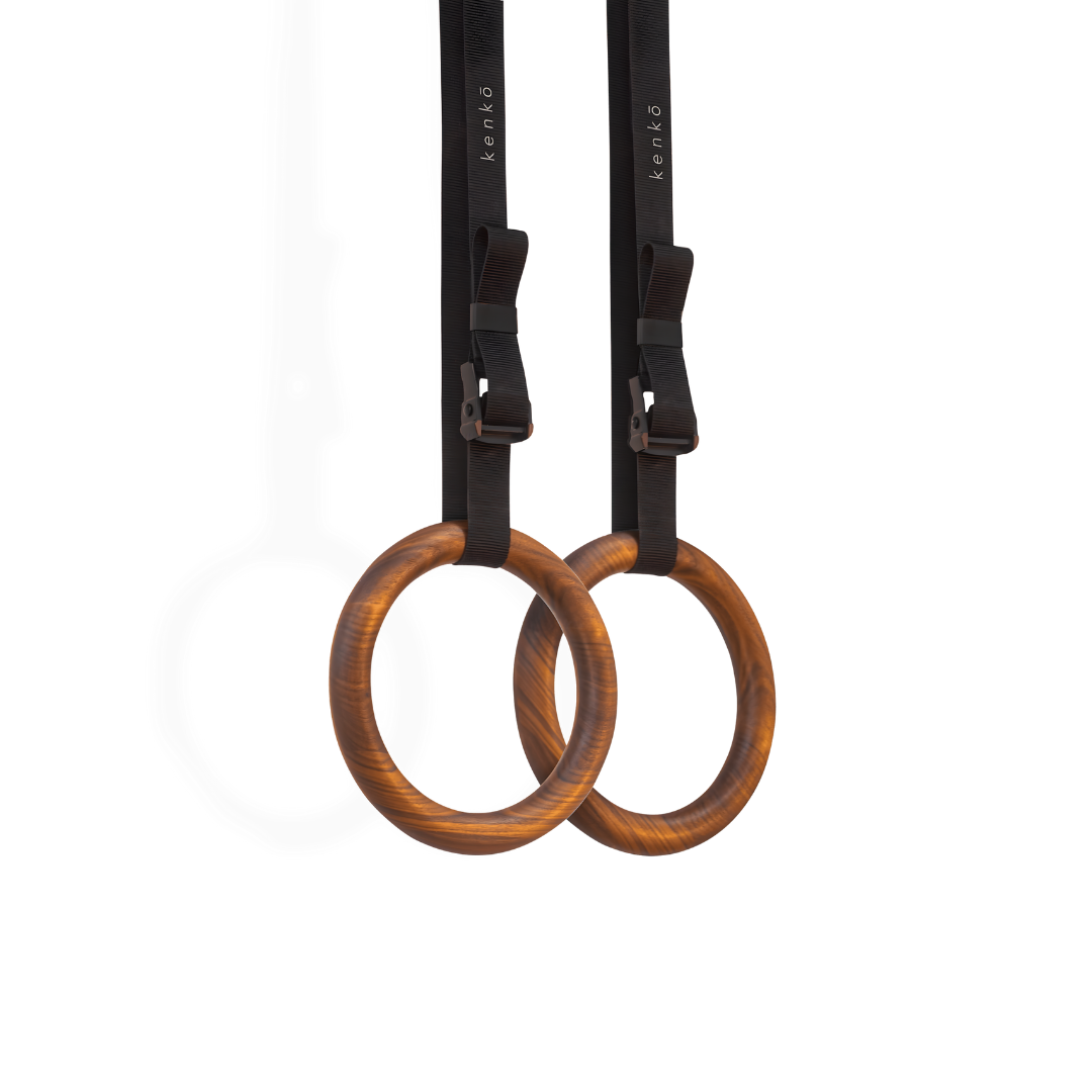 Gym rings made from dark walnut wood with a warm, rich grain.