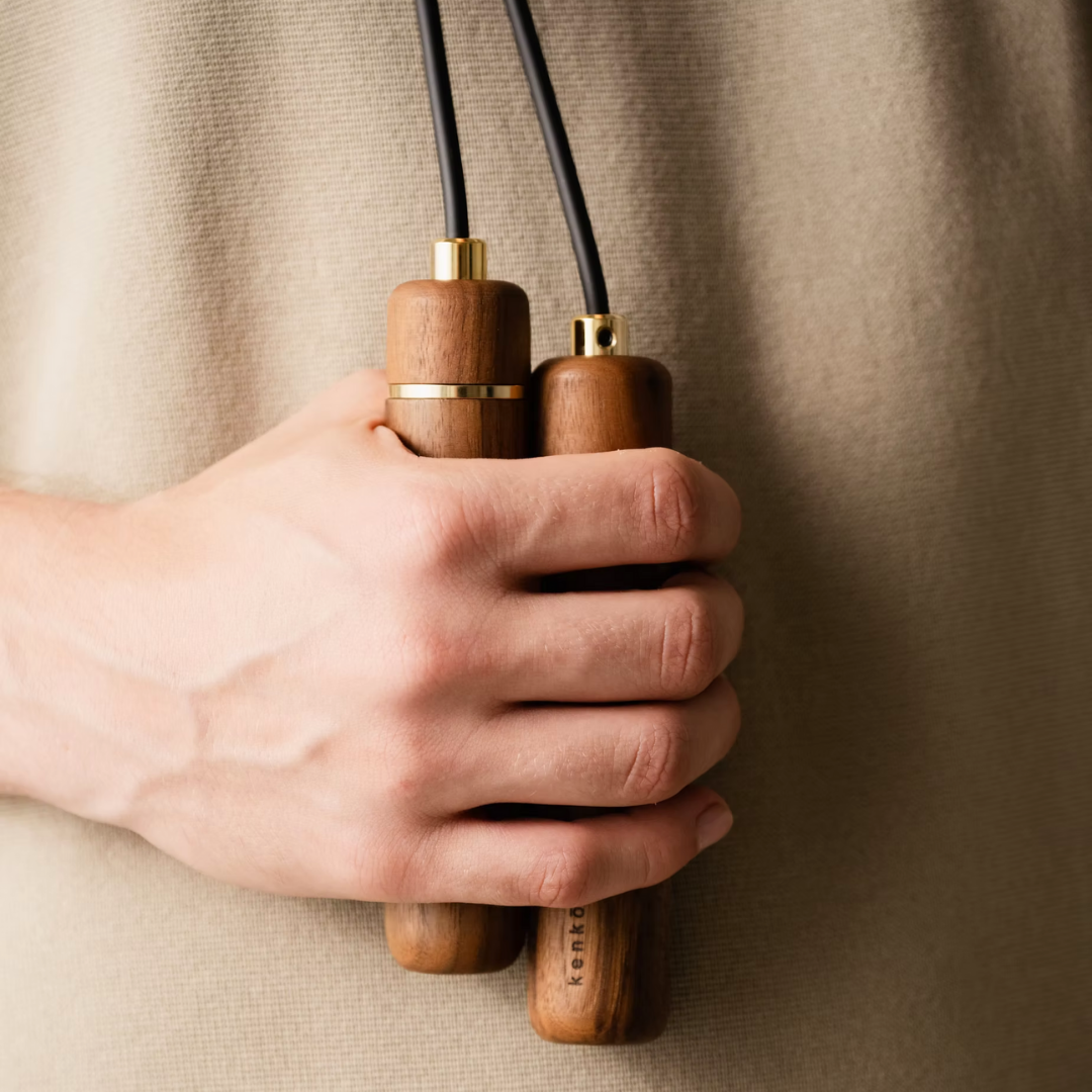 Person holding kenko walnut  skipping rope.