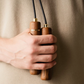 Person holding kenko walnut  skipping rope.