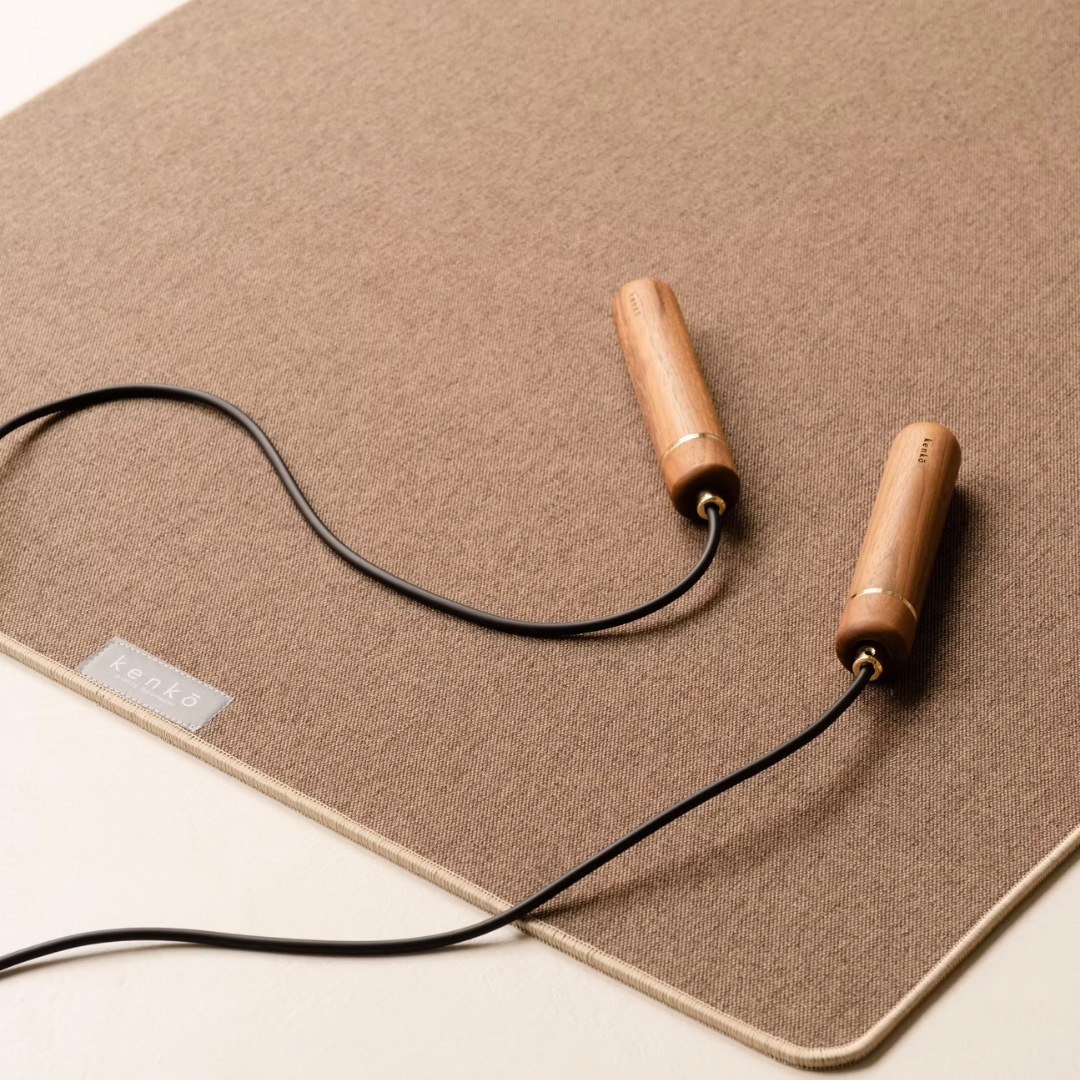 American walnut handle skipping rope with coiled natural rubber rope.