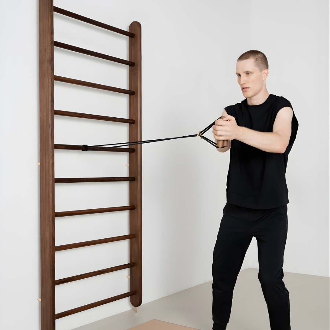 Man using a wall-mounted pull-up bar in a minimalistic room.