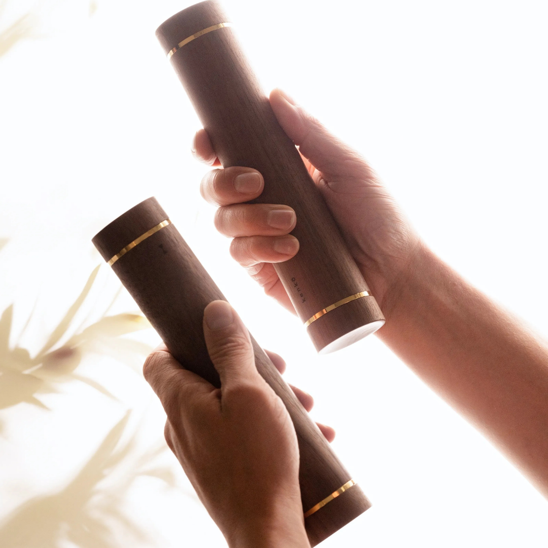 Close-up of walnut handle with polished metal detailing on Kenko Aerobic Dumbbell.
