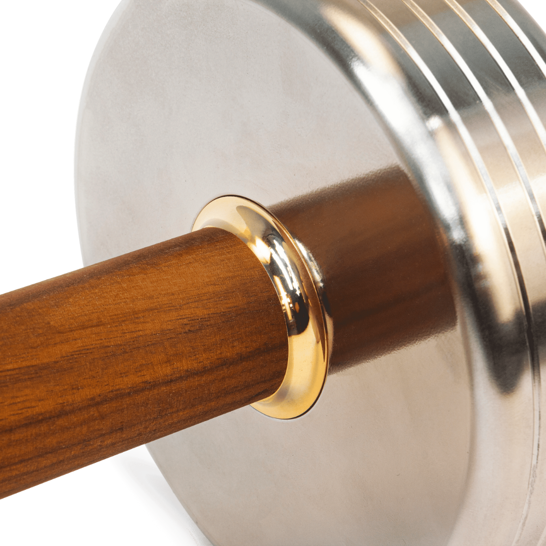 Refined detail of turned stainless steel core and gold-plated brass fittings.