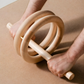 Abdominal roller crafted from premium wood with a central rolling surface.