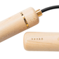 Wooden kenko jump rope with gold accent on a white background.