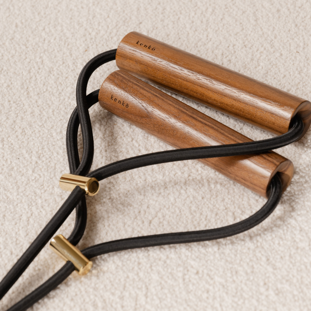 Kenko resistance expander showing two wooden grips and central elastic cord