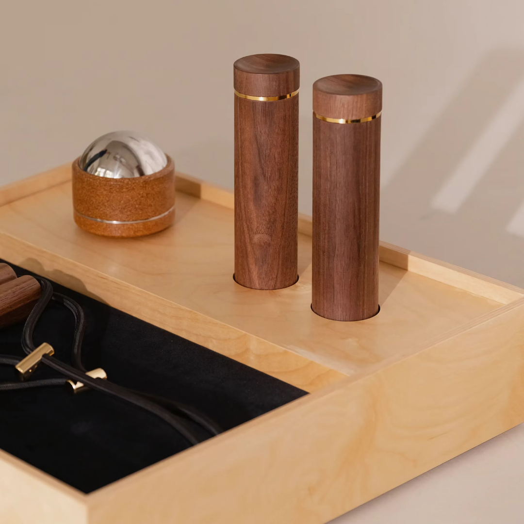 Neatly arranged workout tools inside compact wooden storage box.
