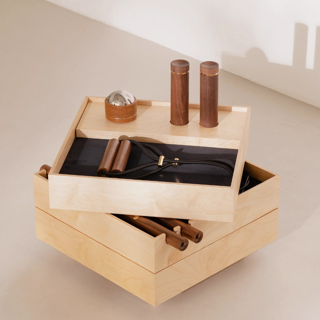 Minimalist home gym kit with curated workout tools housed in sleek wooden box.