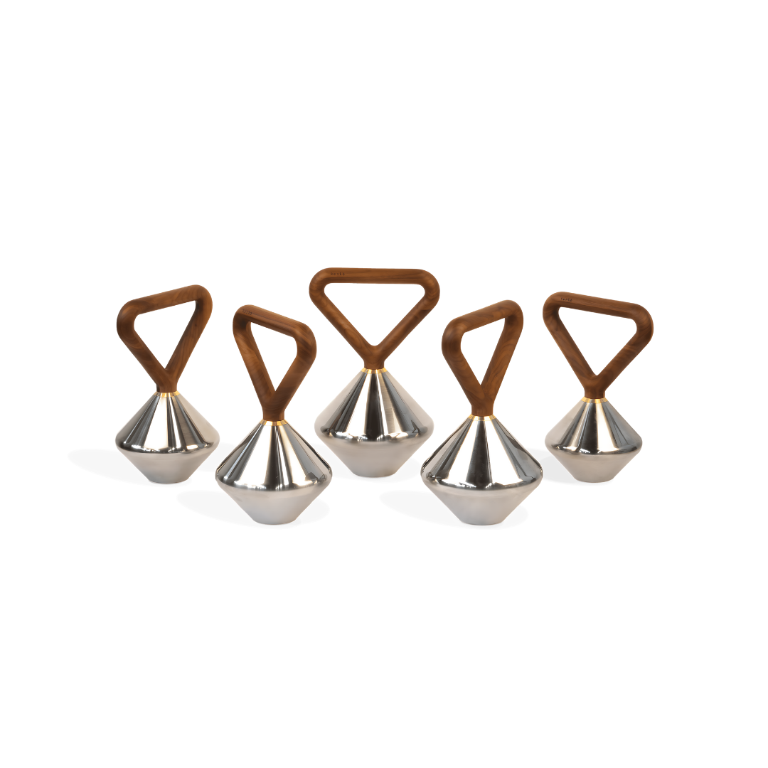 Luxury kettlebell combining solid wood grip, polished stainless steel body, and gold-plated accents.