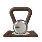 Luxury home gym equipment, premium kettlebell on wooden stand, made with stainless steel and dark walnut wood.