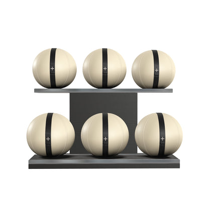 Six beige leather medicine balls with black accent leather, arranged on two shelves made of black ash wood. PENT. MOXA Set Ultimate - Set of 6 Medicine Balls on Horizontal Wooden Stand