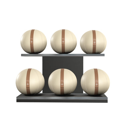 Six beige leather medicine balls with brown accent leather, arranged on two shelves made of black ash wood. PENT. MOXA Set Ultimate - Set of 6 Medicine Balls on Horizontal Wooden Stand