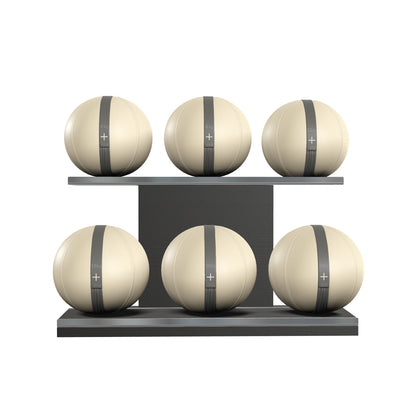 Six beige leather medicine balls with grey accent leather, arranged on two shelves made of black ash wood. PENT. MOXA Set Ultimate - Set of 6 Medicine Balls on Horizontal Wooden Stand