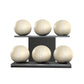 Six beige leather medicine balls with beige accent leather, arranged on two shelves made of black ash wood. PENT. MOXA Set Ultimate - Set of 6 Medicine Balls on Horizontal Wooden Stand