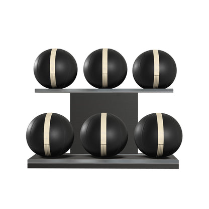 Six black leather medicine balls with beige accent leather, arranged on two shelves made of black ash wood. PENT. MOXA Set Ultimate - Set of 6 Medicine Balls on Horizontal Wooden Stand