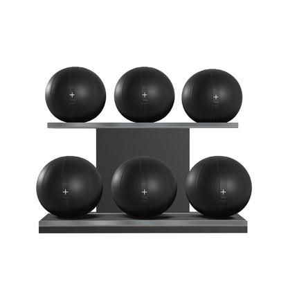 Six black leather medicine balls with black accent leather, arranged on two shelves made of black ash wood. PENT. MOXA Set Ultimate - Set of 6 Medicine Balls on Horizontal Wooden Stand