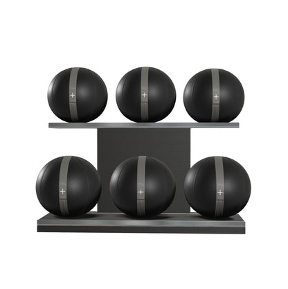 Six black leather medicine balls with grey accent leather, arranged on two shelves made of black ash wood. PENT. MOXA Set Ultimate - Set of 6 Medicine Balls on Horizontal Wooden Stand