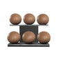 Six brown leather medicine balls with brown accent leather, arranged on two shelves made of black ash wood. PENT. MOXA Set Ultimate - Set of 6 Medicine Balls on Horizontal Wooden Stand
