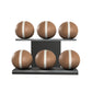 Six brown leather medicine balls with beige accent leather, arranged on two shelves made of black ash wood. PENT. MOXA Set Ultimate - Set of 6 Medicine Balls on Horizontal Wooden Stand