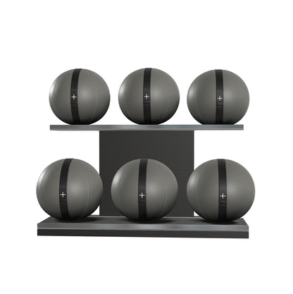 Six grey leather medicine balls with black accent leather, arranged on two shelves made of black ash wood. PENT. MOXA Set Ultimate - Set of 6 Medicine Balls on Horizontal Wooden Stand
