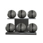 Six grey leather medicine balls with black accent leather, arranged on two shelves made of black ash wood. PENT. MOXA Set Ultimate - Set of 6 Medicine Balls on Horizontal Wooden Stand