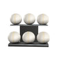 Six white leather medicine balls with white accent leather, arranged on two shelves made of black ash wood. PENT. MOXA Set Ultimate - Set of 6 Medicine Balls on Horizontal Wooden Stand