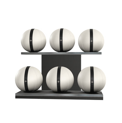 Six white leather medicine balls with black accent leather, arranged on two shelves made of black ash wood. PENT. MOXA Set Ultimate - Set of 6 Medicine Balls on Horizontal Wooden Stand