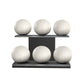 Six white leather medicine balls with white accent leather, arranged on two shelves made of black ash wood. PENT. MOXA Set Ultimate - Set of 6 Medicine Balls on Horizontal Wooden Stand