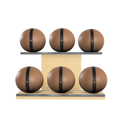 Six brown leather medicine balls with black accent leather, arranged on two shelves made of natural ash wood. PENT. MOXA Set Ultimate - Set of 6 Medicine Balls on Horizontal Wooden Stand