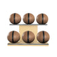 Six brown leather medicine balls with black accent leather, arranged on two shelves made of natural ash wood. PENT. MOXA Set Ultimate - Set of 6 Medicine Balls on Horizontal Wooden Stand