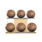 Six brown leather medicine balls with brown accent leather, arranged on two shelves made of natural ash wood. PENT. MOXA Set Ultimate - Set of 6 Medicine Balls on Horizontal Wooden Stand