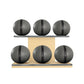 Six grey leather medicine balls with black accent leather, arranged on two shelves made of natural ash wood. PENT. MOXA Set Ultimate - Set of 6 Medicine Balls on Horizontal Wooden Stand
