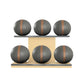 Six grey leather medicine balls with brown accent leather, arranged on two shelves made of natural ash wood. PENT. MOXA Set Ultimate - Set of 6 Medicine Balls on Horizontal Wooden Stand