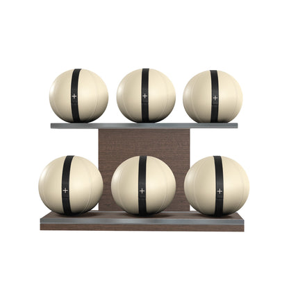 Six beige leather medicine balls with black accent leather, arranged on two shelves made of natural walnut wood. PENT. MOXA Set Ultimate - Set of 6 Medicine Balls on Horizontal Wooden Stand