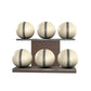 Six beige leather medicine balls with grey accent leather, arranged on two shelves made of natural walnut wood. PENT. MOXA Set Ultimate - Set of 6 Medicine Balls on Horizontal Wooden Stand