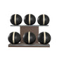Six black leather medicine balls with white accent leather, arranged on two shelves made of natural walnut wood. PENT. MOXA Set Ultimate - Set of 6 Medicine Balls on Horizontal Wooden Stand