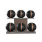 Six black leather medicine balls with brown accent leather, arranged on two shelves made of natural walnut wood. PENT. MOXA Set Ultimate - Set of 6 Medicine Balls on Horizontal Wooden Stand
